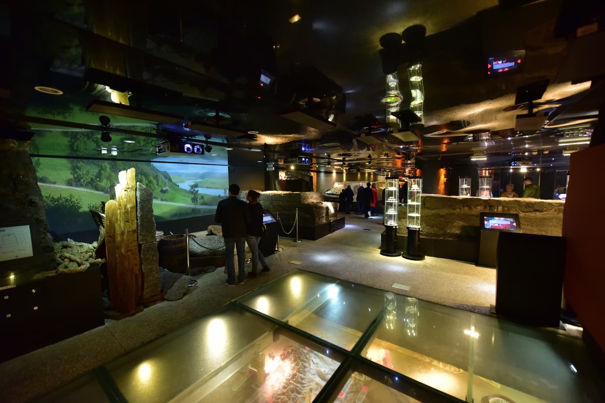 The immersive Rynek Underground museum beneath Kraków's Main Market Square — glass walkways over medieval excavations, illuminated display cases and projected scenes of the old city.